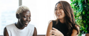 Two woman laughing in an office