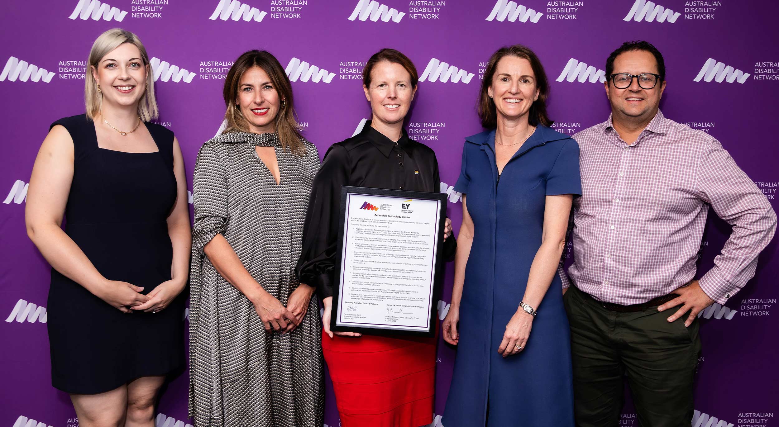 Left to right: Australian Disability Network Head of Strategy, Amber O'Shea, with Procurement Charter signers, Michelle Hyams, Louise MacDonald, Nicola Commins, Mathew Nelson. Louise is holding the charter in a frame.
