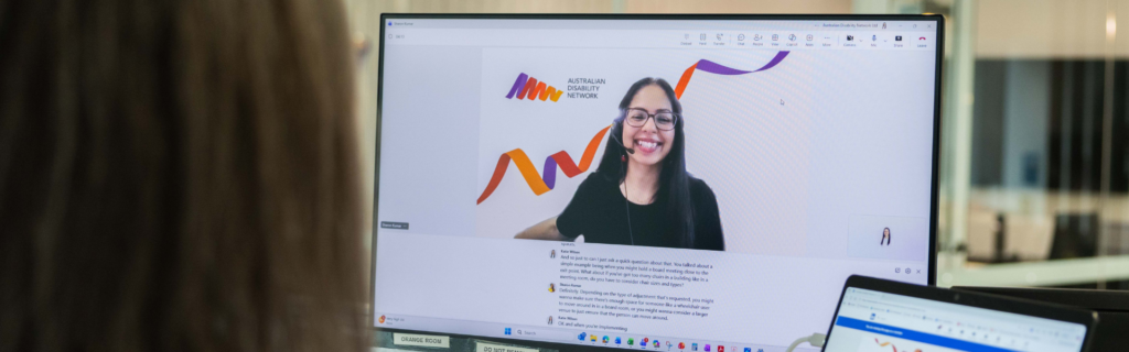 Image of a smiling woman on a video call on a computer screen.